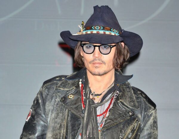 Johnny Depp donning a leather jacket and Cow Bone and Brown Leather Silver Buckle Cowboy Hat Band.