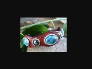 A Silver Concho Brown Leather Turquoise Bracelet USA with turquoise stones and silver accents.