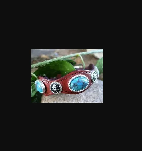 A Silver Concho Brown Leather Turquoise Bracelet USA with turquoise stones and silver accents.