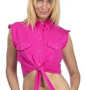A blond woman in a pink shirt posing for a photo.