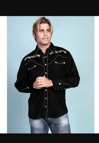 A man in a Mens "Western Tones" Black pipe western shirt by Scully posing for a photo.