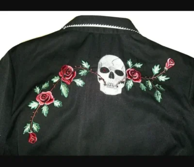A black jacket with a "Skull and Roses" Men's western embroidered shirt on it.