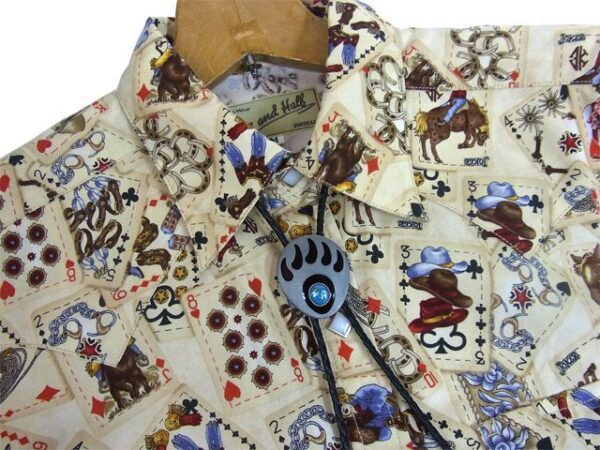 A men's shirt with Silver Bear Claw Turquoise Bolo Tie on it.
