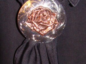 A Golden Rose Silver Western scarf slide on a black shirt.