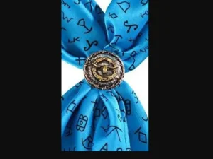 A blue Two Tone Longhorn Barbed Wire Western Scarf Slide with a symbol on it.