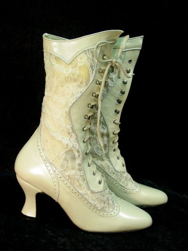 A pair of SIZE 5.5 Vesper Ivory leather and lace granny boots on a black background.