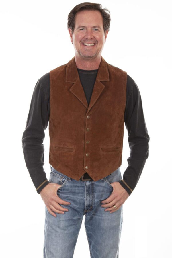 A man wearing a brown suede vest and jeans.