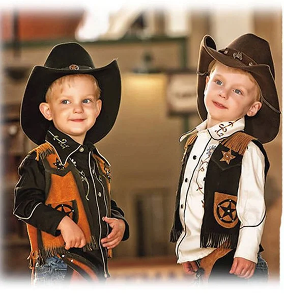 Two little boys dressed as cowboys.