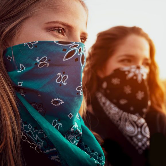 Two women wearing scarfs with open hair