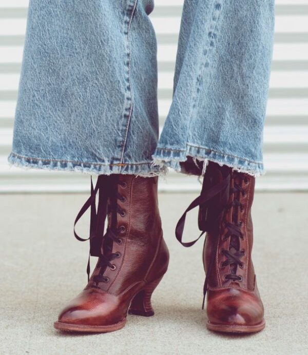 A woman's legs in jeans and lace up boots, showcasing her stylish Eleanor Merlot Wine Leather Womens Granny Boots.