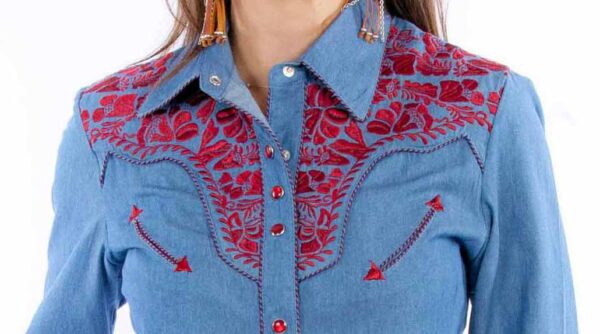 A woman in a Scully Womens Cranberry Embroidered Blue Western Shirt with red embroidery.