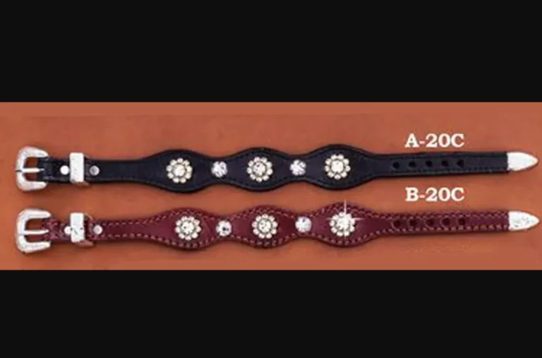 A Rhinestone Flower Western Leather Bracelet with studs on them.