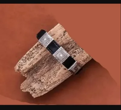 A Square Silver Western Leather Cowboy Bracelet USA made on a piece of wood.