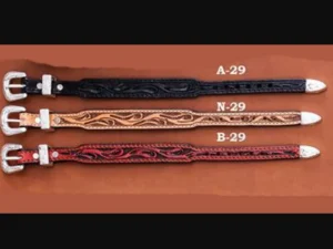 A pair of Leather Western Tooled Cowboy Belt Bracelets with different designs on them.