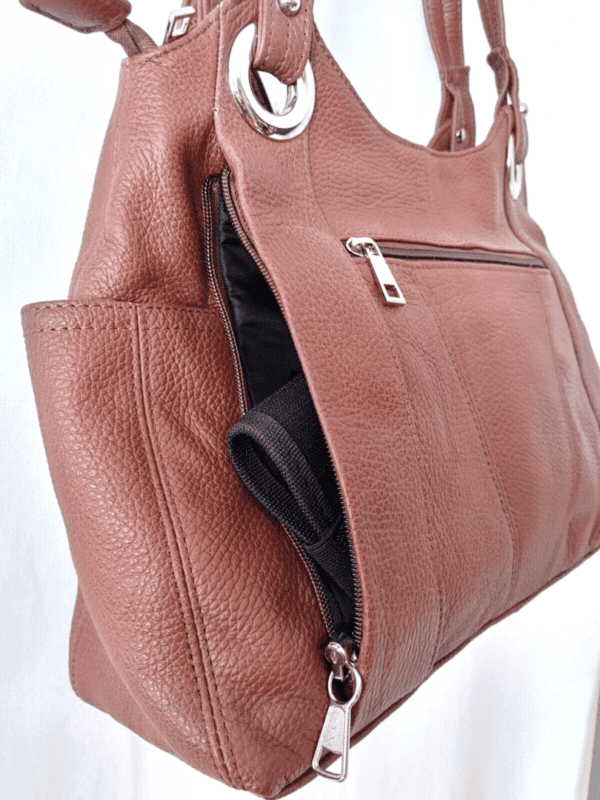 A "Diane" Women's Black Leather Concealed Carry Handbag w/ Holster with a zippered pocket.