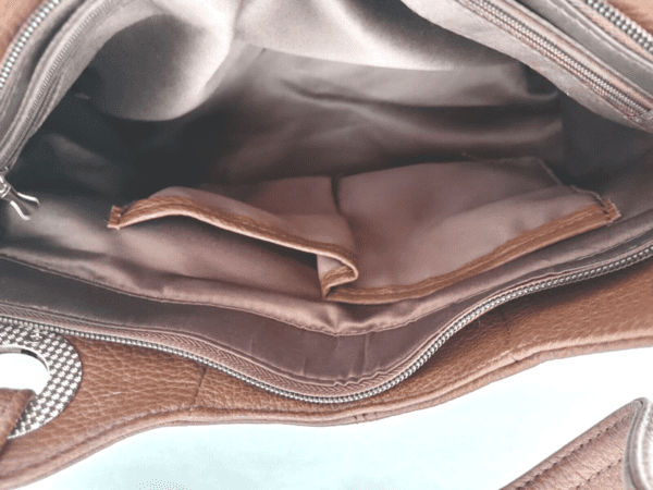 The inside of a "Diane" Women's Black Leather Concealed Carry Handbag w/ Holster.