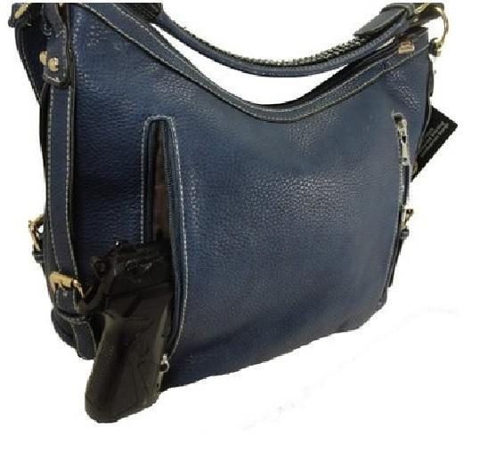 A "Lisa" Women's Vegan Leather Blue Concealed Handbag with a gun attached to it.