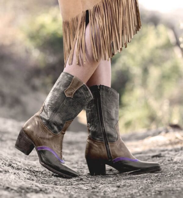 A woman wearing cowboy boots and a fringe skirt, also sporting Basanti Side Zipper Purple Striped Black Leather Lace Women's Granny Boots.