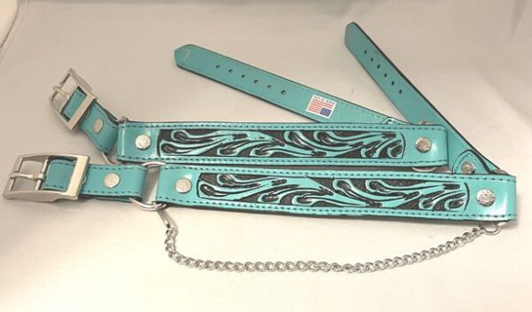 A Turquoise & Black Tooled Leather Cowboy boot chains and black dog collar with a chain on it.