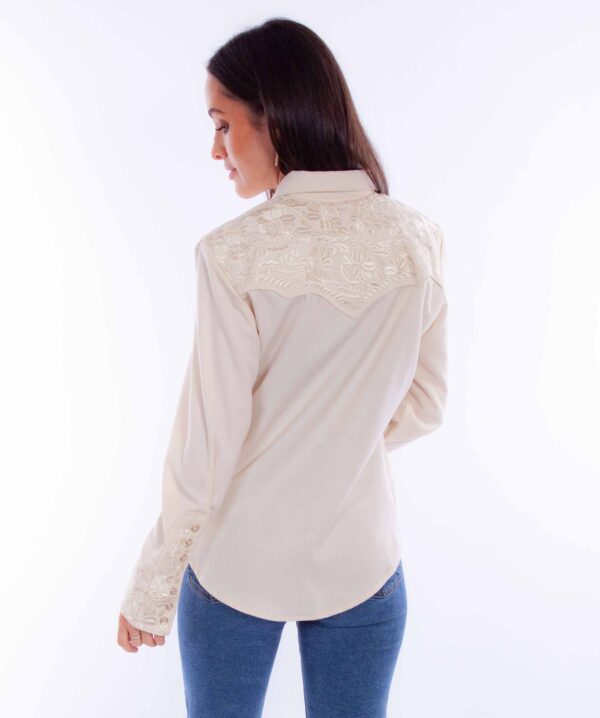 The back view of a woman wearing jeans and the Scully Gunfighter Women's Ivory Embroidered Western Shirt.